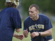 The Seton Catholic High School football Head Coach Dan Chase instructs his team during practice at Cascade Middle School on Thursday May 31, 2012.