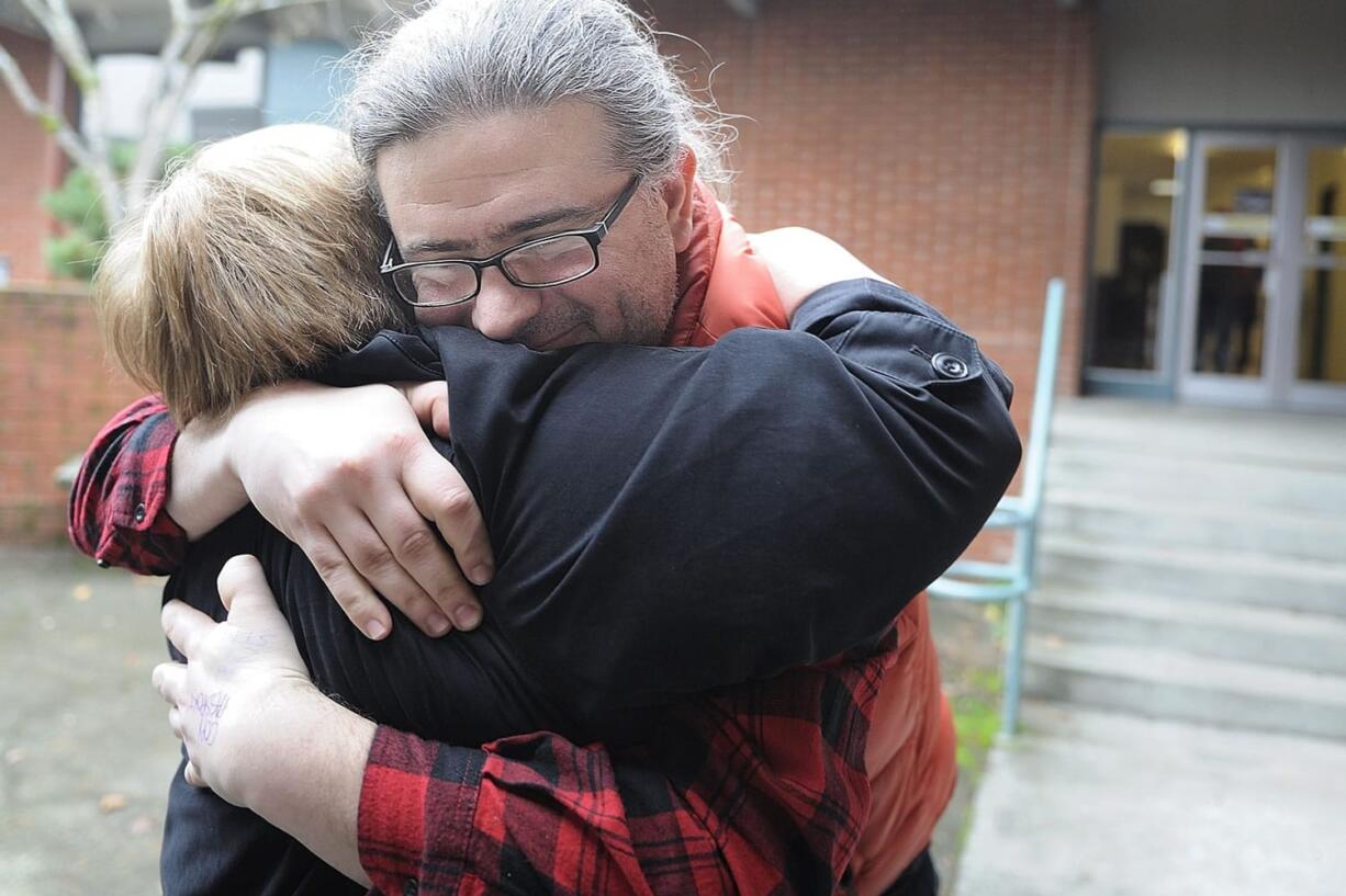 Ismet Prcic is embraced by Pat Rohrbach, program coordinator and costume designer at Clark College, Monday January 9, 2012 at Vancouver, Washington. &quot;Theater saved my life,&quot; said Ismet Prcic, an adjunct drama instructor at Clark College, who wrote a book about growing up in Bosnia during the war.