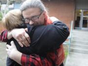 Ismet Prcic is embraced by Pat Rohrbach, program coordinator and costume designer at Clark College, Monday January 9, 2012 at Vancouver, Washington. &quot;Theater saved my life,&quot; said Ismet Prcic, an adjunct drama instructor at Clark College, who wrote a book about growing up in Bosnia during the war.