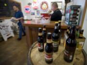 Travis Carter, left, and Peter Wallace, co-owners of Northwest Liquid Gold, hope to expand their store to include a beer garden and deli later this year.