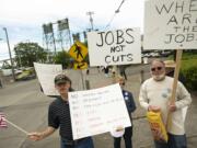 Demonstrators line Columbia Street on Friday as U.S. Rep. Jaime Herrera Beutler, R-Camas, kicks off her campaign for re-election at a private event at the Red Lion Hotel Vancouver at the Quay.