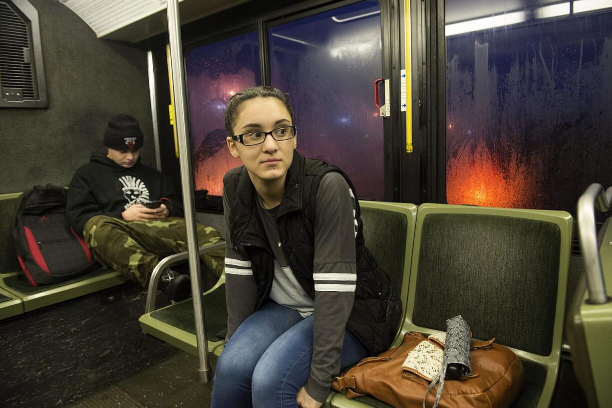 Mountain View High School junior Selena Vera, 16, center, catches a ride to school on a C-Tran bus Thursday morning using the Youth Opportunity Pass. Patrick Nation, 18, rides in the background.