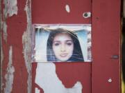 A photograph of Maria Delos-Carrasco Angulo is part of a memorial near the Fourth Plain Boulevard crosswalk where she was killed by a hit-and-run driver last week.