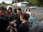 Steven Lane/The Columbian
Neighbors who witnessed the hit-and-run that killed  Maria Delos-Carrasco Angulo light candles in her memory Friday night in Vancouver. Angulo died Thursday night after being struck by a car as she crossed Fourth Plain Boulevard in a crosswalk.