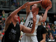 Union guard Tyler Copp (10) works inside against Gig Harbor guard Jared Murphy (20) in opening round of bi-district boys basketball tournament.