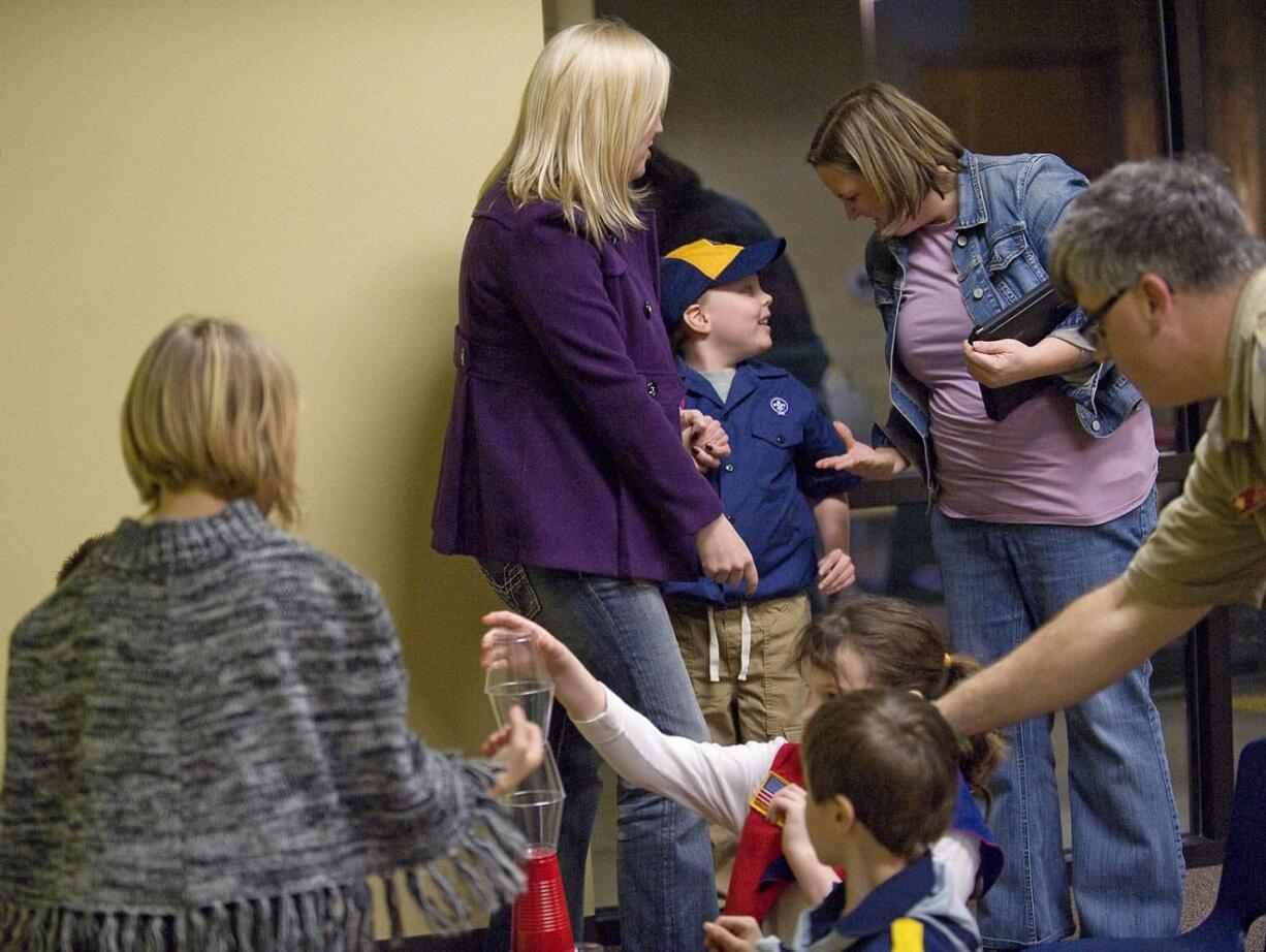 Alicia Miner, back left, her son Austin Porter, 8, and his therapist, Corinne Weaver, emerge from a meeting of the sensory-friendly Cub Scout pack in Vancouver.