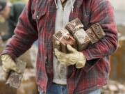 Doug Johnson salvages bricks that had been part of Battle Ground's Central School, which was burned in a Jan.