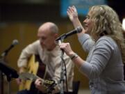 Becky Manuel leads the worship portion of a 30-plus singles group at Crossroads Community Church.