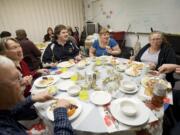 Winter Hospitality Overflow volunteers Dennis and Diane Smith, from left, share Christmas dinner with recipients Brandon Pesterfield, Brittany Meeker and Cheryl Harvey at St.