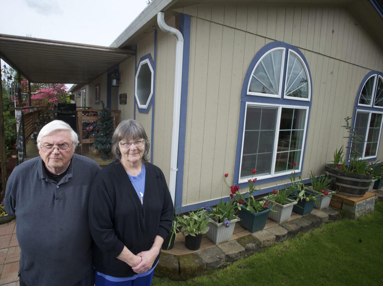 Earl and Clydene Gere, who recently lost an appeal of their property value to the Board of Equalization, stand in front of their partially rebuilt Brush Prairie mobile home.