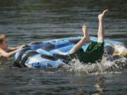 Vancouver residents Tyler Bacon, 10, left, and his brother Matthew Bacon, 13, cool off at Klineline Park on a hot day in 2016.