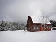 A 1940s-era barn at the Kaye Ney residence completes a snowy winter scene on Sunday in the Highland neighborhood above La Center.