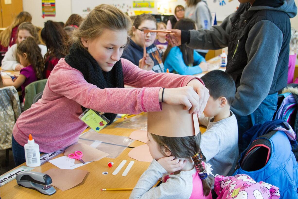 Woodland: Woodland High School students show children from the Woodland Preschool Cooperative how to make reindeer hats as part of the high school&#039;s Early Childhood Development program.