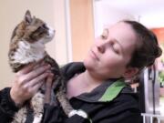 Walnut Grove: Alison Day holds Ocelot, one of the seven cats at her home shelter in Kelso who were brought to Furry Friends and adopted out after a landslide left Day&#039;s home in danger.