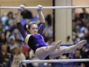 Jennifer Debellis of Columbia River High School scored a 9.4 on the uneven bars in the WIAA 3A gymnastics finals competition Saturday February 18, 2012 in Tacoma, Washington.