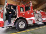 Dan Pearce, captain at Vancouver Fire Station 1, climbs out of his station's new engine on Tuesday.