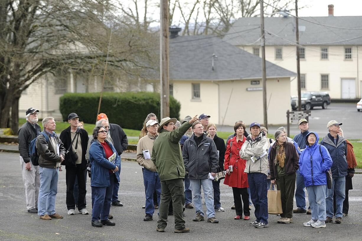 Bob Cromwell, an archaeologist with the National Park Service, points out a historical building during a tour of the East Barracks.