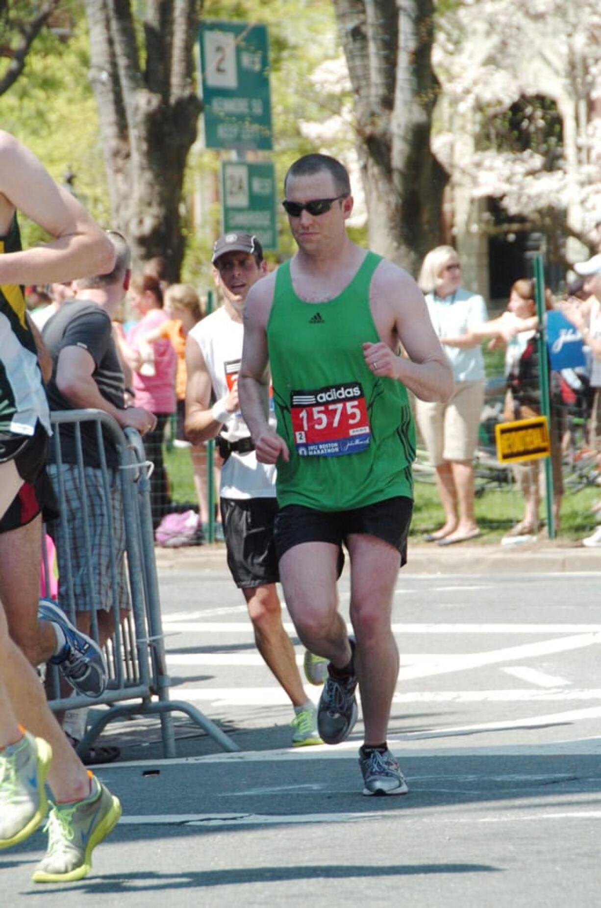 Columbian News Editor Micah Rice (1575) rounds a corner near mile 18 of the Boston Marathon on April 16.