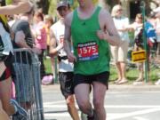 Columbian News Editor Micah Rice (1575) rounds a corner near mile 18 of the Boston Marathon on April 16.