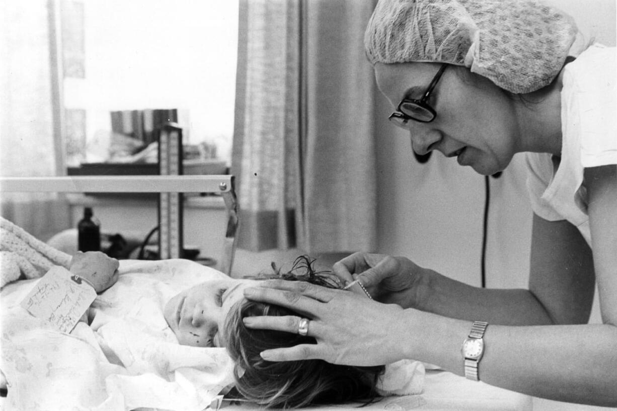 Almost like an assembly line, nurses shaved the heads of children so their cuts could be sutured.