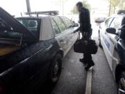 Vancouver police officer Ken Suvada prepares a patrol vehicle at Vancouver Police Department's West Precinct for his swing shift.