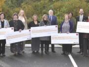 Andresen/St. Johns: Wells Fargo managers present $1,000 checks to Clark County school officials at a breakfast for elementary school principals on Nov.