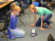 Ridgefield: View Ridge Middle School seventh-graders Helena Bockstadter, left, and Lauren Rath study a robot in their applied technology class.