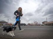 Teri Wilson runs with her 15-month-old Cavalier King Charles spaniel, Luna, on Northeast 99th Street on Wednesday. Luna had a severely broken leg when she was rescued from a home.