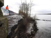 WSDOT spokesman Bart Treece stands  near a portion of Lower River Road that has been eroded by the Columbia River. After gating the road a little past Milepost 10 west of Frenchman&#039;s Bar in Vancouver last summer, WSDOT plans to transfer it to Clark County.