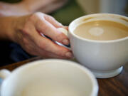 Anne McEnerny-Ogle enjoys an espresso drink during a meeting  at Latte Da Coffee House to discuss neighborhood issues and to make connections.