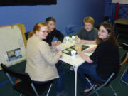 Bella Vista: Erin, James, and Maggie Altenhof-Long and Spencer Warner play board games.