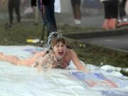 Battle Ground: Heather Hash of Vancouver participates in the Polar Bear Slide at the Resolution Run in Battle Ground.