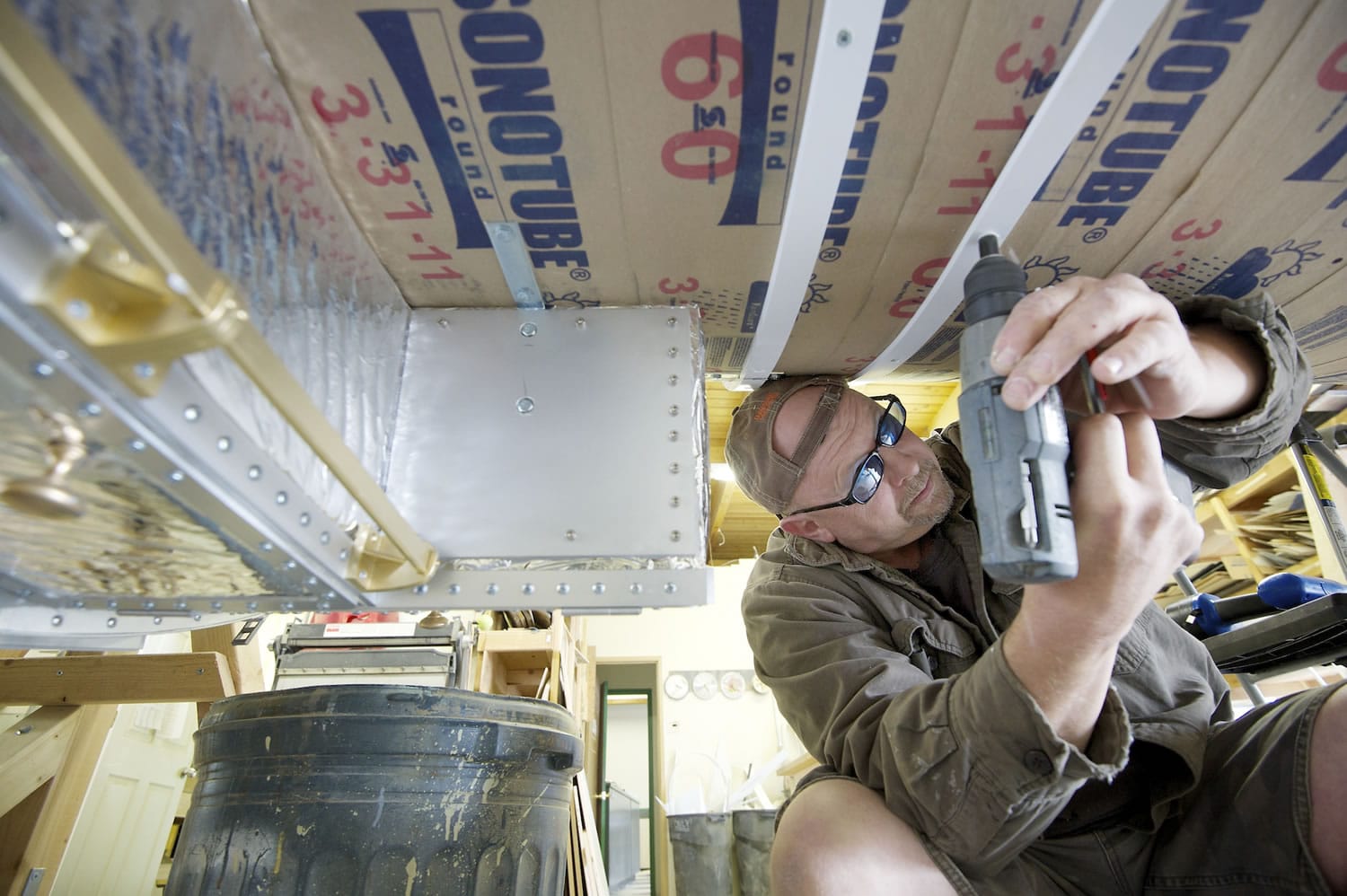 Matt Kilwein, a model maker at Masterpiece Models, installs straps Wednesday June 6, 2012. Model makers are working on building a half-scale replica of Hubble Telescope for the Museum of Flight in Seattle.