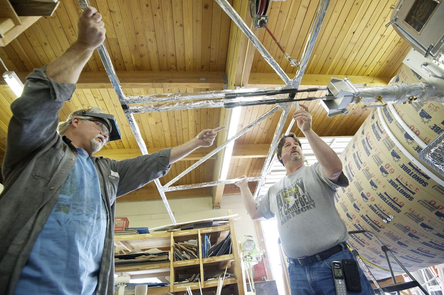 Ed Warmack, left, and John Geigle, owner of Masterpiece Models, check the fitting of a part Wednesday June 6, 2012. Model makers are working on building a half-scale replica of Hubble Telescope for the Museum of Flight in Seattle.