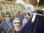 From left to right: model makers Ed Warmack, Matt Kilwein, Robert Willard, and John Geigle, owner of Masterpiece Models, stand next to a model of Hubble Wednesday June 6, 2012. Model makers are working on building a half-scale replica of Hubble Telescope for the Museum of Flight in Seattle.