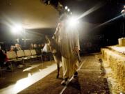 Joseph (Cody Calhoon) leads Danny, the donkey, carrying Mary (Hannah Bishop), to Bethlehem during a living Nativity Saturday at the Living Hope Church.