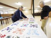 Mary Myers, 62, from Camas, left, and Toni Kapitanovich, 65, from Battle Ground, plan a quilting project at the Washington Grange No.