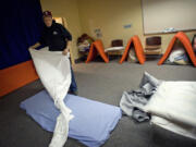 Mark Bailey, 53, gets his bed ready for the night at the Winter Hospitality Overflow shelter at St. Paul Lutheran Church in Vancouver, which houses 24 men a night.