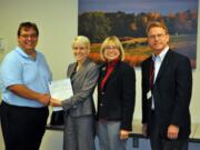 Bagley Downs: Vaughn Schmall, left, of Wells Fargo, awards a $3,000 grant to Empower Up board members Tanya Gray, solid waste supervisor with the city of Vancouver; Lisa Schmidt, chairwoman of the Clark County Environmental Services Advisory Board; and Steven Rusk, business administrator for the Salvation Army of Clark County.