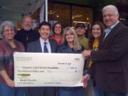 Cascade Highlands: New Seasons Market donates $5,000 to the Evergreen School District Foundation to show its support for local schools. Front row from left: Joan Skelton, school board president; Todd Yuzuriha, school board member; Teresa Ohrt, teacher; Kris Greene, Evergreen School District Foundation president. Back row from left: T.