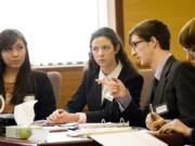 Photos by Steven Lane/The Columbian
Hudson's Bay High School defense team members, from left, Kimberly Becerra, Amber Finder, Luke Johnson and Jonathan Muck discuss their case during a mock trial Thursday afternoon at the Clark County Courthouse. Top: Superior Court Judge Robert Lewis listens to testimony Thursday.