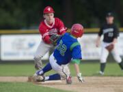 Fort Vancouver's Anthony Gardner tags out Mountain View's Jake Shelley (32)  during the second game Wednesday.