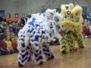 Portland Lee's Association Lion Dance Team performs during a program to celebrate the Chinese New Year at Ben Franklin Elementary School on Friday.