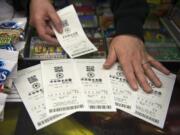 A customer purchases Powerball tickets at Plaid Pantry on Kaufmann Avenue Tuesday evening.