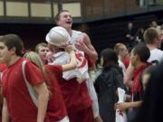 Union's Tyler Copp is lifted after a win against Evergreen and clinching the 4A GSHL league title at UHS on Friday February 3, 2012.