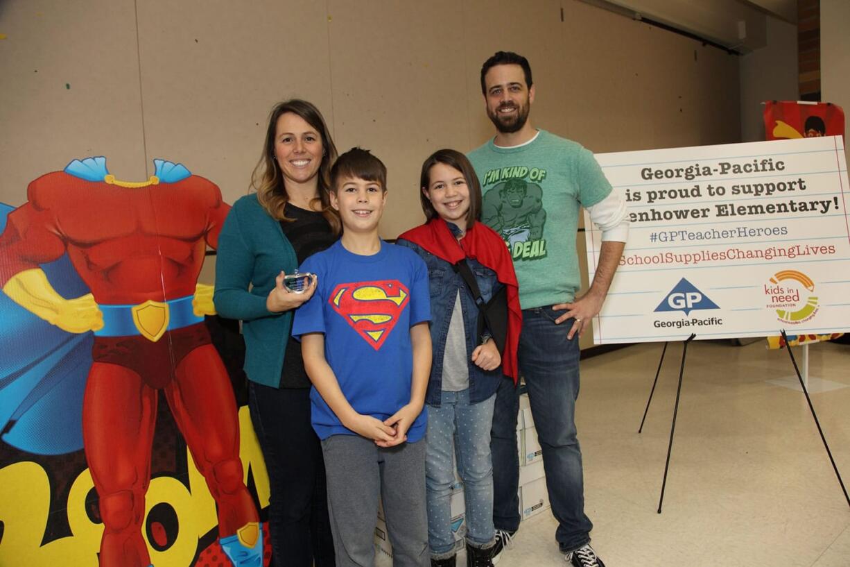 Lake Shore: Eisenhower Elementary School teacher Tricia Hoffarth, with her husband, Erick Hoffarth, and their two children, appear at a school assembly, in which she was honored with a teacher hero award from The Kids in Need Foundation.