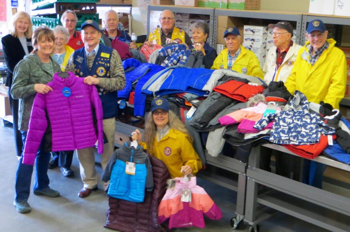 Meadow Homes: Members of the Fort Vancouver Lions with some of the 100-plus winter items they collected to donate to Share as part of their Warm Winter Clothing Campaign.