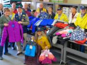 Meadow Homes: Members of the Fort Vancouver Lions with some of the 100-plus winter items they collected to donate to Share as part of their Warm Winter Clothing Campaign.