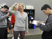 Sean Hibbard, left, and Josh Hibbard, right, take measurements for Jadine Juarez as she begins an eight-week nutrition program Tuesday at Results Fitness Training in Camas. The new fitness facility offers group TRX, yoga and Pilates classes, as well as the nutrition program.