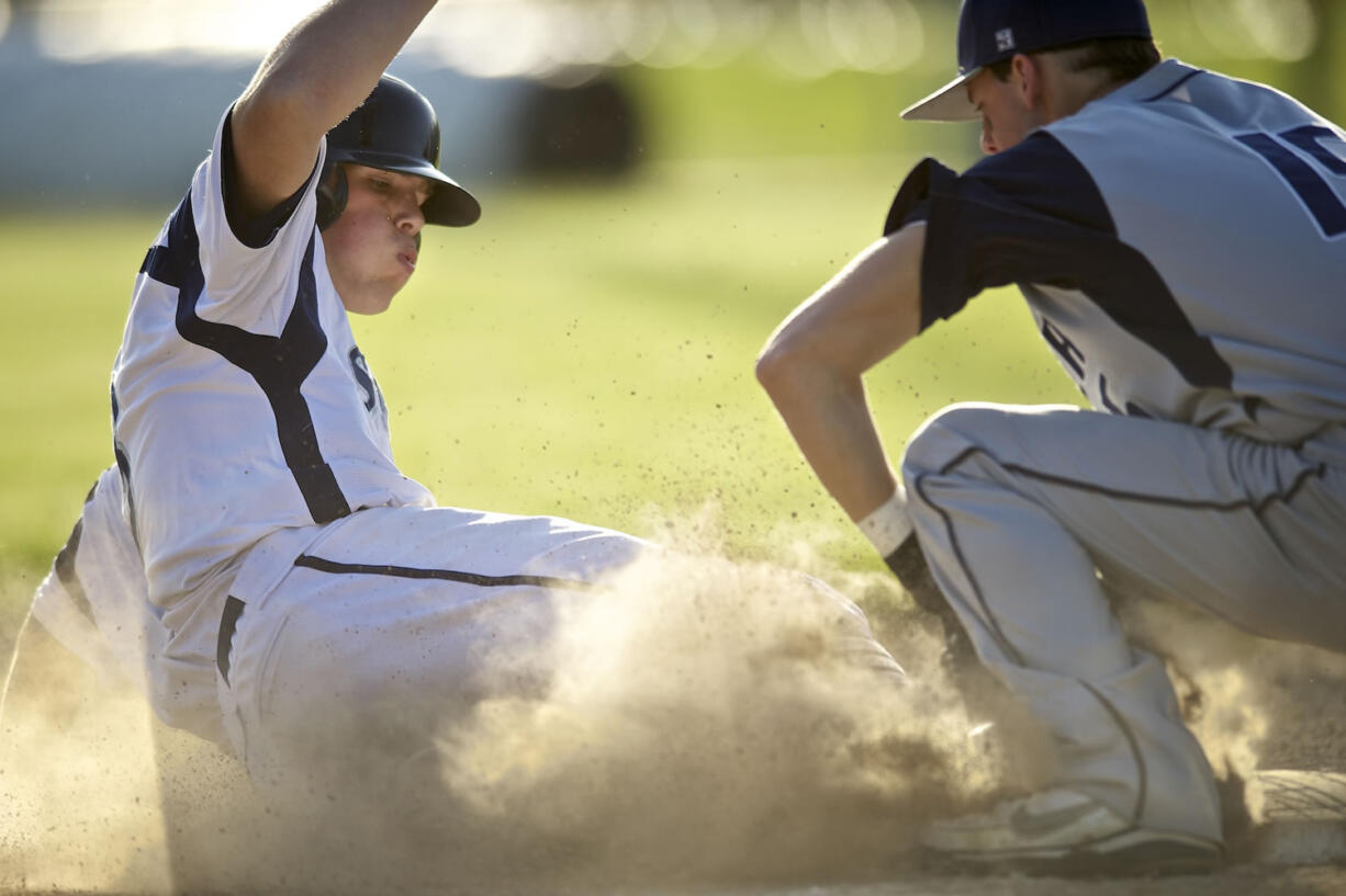 Brayden Maney, left, of Skyview High School is tagged out by Jaden Sawyer of Todd Beamer High School .